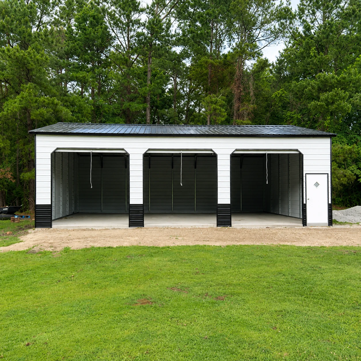 Enclosed metal garage with an open lean-to carport attached to the side