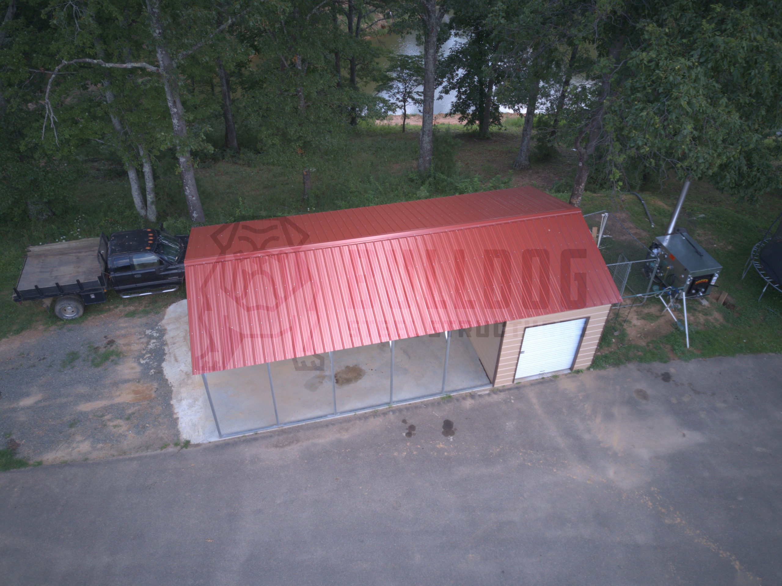 Aerial view of car port with red roof and storage shed attached