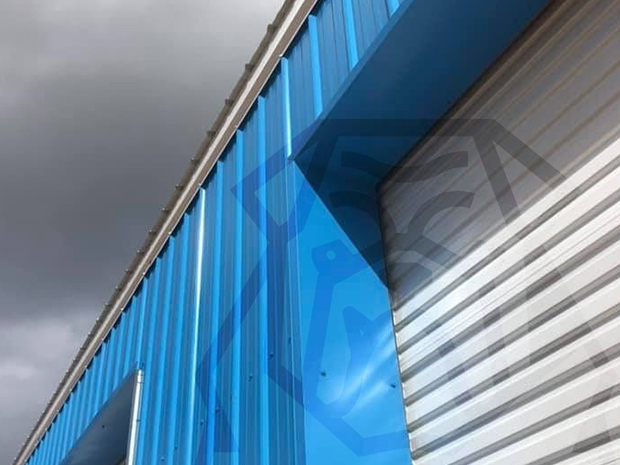 blue custom metal building with vertical siding